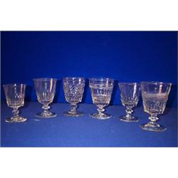 A COLLECTION OF SIX BUCKET RUMMERS, IRISH, EARLY 19th CENTURY, on knopped stems....