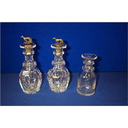 A PAIR OF INDIVIDUAL CLUB SHAPED DECANTERS, IRISH, c.1840, now with brass mounted stoppers in the...