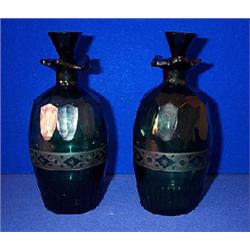 A RARE PAIR OF GREEN BARREL DECANTERS, c.1800, WATERFORD, with faceted shoulders, cut fluted base...