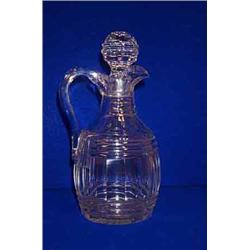 A PRISMATIC AND FACET CUT CLARET JUG, c.1830, with star cut base, with associated stopper, 31cm...