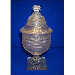 AN URN SHAPED CUT GLASS JAR AND COVER, IRISH, EARLY 19th CENTURY, with domed knob lid, the body c...