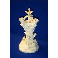 A BELLEEK "BIRD NEST STUMP" VASE, FIRST PERIOD, (1863-1890), with a bird perched on top, another...