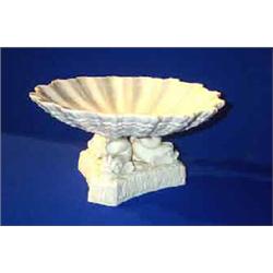 A BELLEEK "TRI-DOLPHIN LOW COMPORT", FIRST PERIOD, (1863-1890), the shell dish resting on three d...
