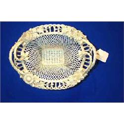 A BELLEEK "HENSHALL'S TWIG" TWO HANDLED BASKET, the rim decorated with flowers, the centre three...