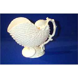 A BELLEEK "NAUTILUS" JUG, FIRST PERIOD, (1863-1890), modelled as one shell resting on another, co...