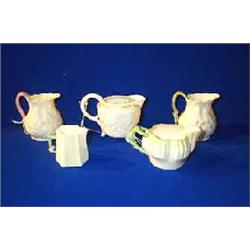 A COLLECTION OF FIVE BELLEEK SMALL MILK JUGS, SECOND AND THIRD PERIODS....