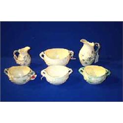 A COLLECTION OF BELLEEK IVY PATTERN, comprising a milk jug, first period painted in greens and gr...