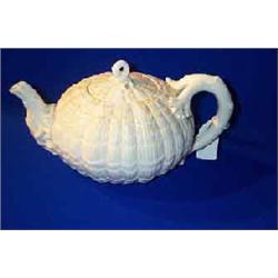 A BELLEEK "TRIDACNA" WHITE GLAZED TEAPOT AND COVER, SECOND PERIOD, (1891-1926), transfer printed...