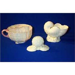 A BELLEEK CORAL MOUSTACHE CUP, FIRST PERIOD (1863-1890), (restoration); and a nautilus shell vase...
