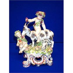 A DUESBURY DERBY GROUP, c.1800, of bacchic amorini, the children garlanded with fruiting vine and...