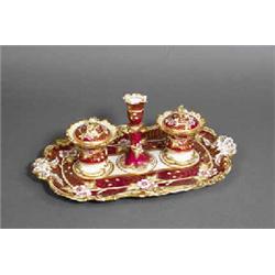 A PORCELAIN STANDISH, IN ROCKINGHAM STYLE, comprising a moulded tray fitted with two pots and a c...