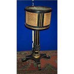 AN EBONISED AND PARCEL GILT JARDINIERE, c.1840, the caned and fluted top with a zinc liner, flute...