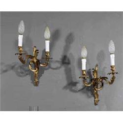 A SET OF FOUR GILT METAL TWO BRANCH WALL SCONCES, IN FRENCH ROCOCO 18th CENTURY STYLE, with folia...