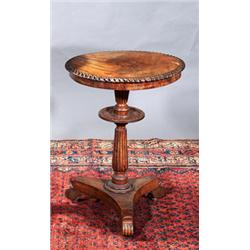 A FADED MAHOGANY SEWING TABLE, c.1820, with gadrooned rim on a baluster support fitted with a pla...