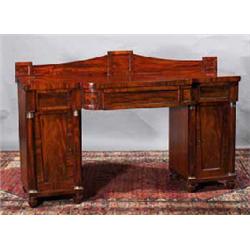 A SMALL FLAME MAHOGANY BREAKFRONT SIDEBOARD, EARLY 19th CENTURY, the crested gallery centred by a...