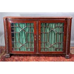 A MAHOGANY SIDE CABINET, IRISH, EARLY 19th CENTURY, with reeded top, above a ropetwist frieze fit...