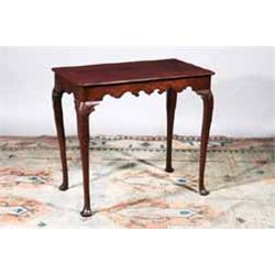 A MAHOGANY TEA TABLE, IRISH, 18th CENTURY, with plain rectangular top, shaped apron and on shell...