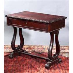 A ROSEWOOD WRITING TABLE, IRISH, c.1840, gadrooned rim fitted with a long frieze drawer above a b...