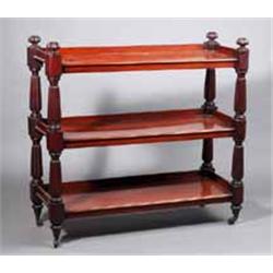 A MAHOGANY THREE TIER DUMB WAITER, c.1840, with galleried shelves supported on inverted reeded co...