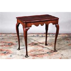 A MAHOGANY TRAY TOP TEA TABLE, IRISH, 18th CENTURY, with shaped apron on moulded cabriole legs on...