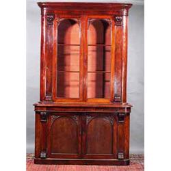 A MAHOGANY BOOKCASE, MID 19th CENTURY, with deep moulded cornice and rounded corners with a pair...