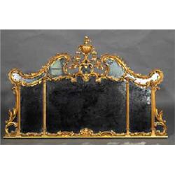 A CARVED COMPARTMENTED GILT OVERMANTEL, IN 18th CENTURY STYLE, the scroll cresting surmounted by...