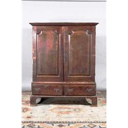 AN OAK PROVINCIAL LINEN PRESS, MID 18th CENTURY, with moulded cornice above a pair of fielded pan...