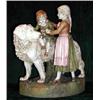 Image 1 : A large Royal Dux porcelain figural group depicting a girl helping a young boy to dismount from...