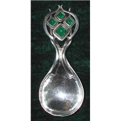 An Art Nouveau hammered silver caddy spoon by Omar Ramsden, inset with four chrysoprase cabochon...