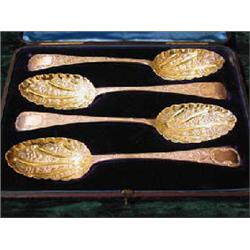 A good cased set of four hallmarked silver and parcel gilt berry spoons, maker John James Whitin...