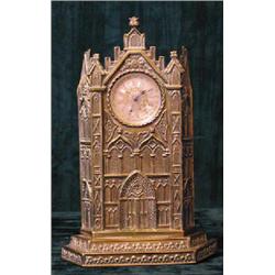 An unusual mid 19th century brass watch stand in the form of a cathedral and embossed with Royal...