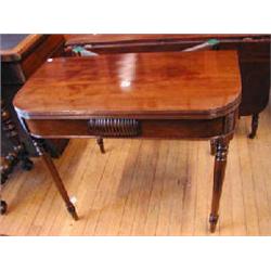 An early 19th century mahogany tea table with foldover top on turned gateleg supports. (Illustra...