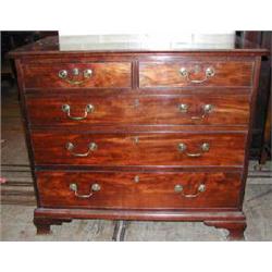 A Georgian mahogany chest of small proportion with two short and three long graduated drawers on...