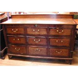 An 18th century oak and mahogany crossbanded mule chest with hinged lid above three dummy drawer...