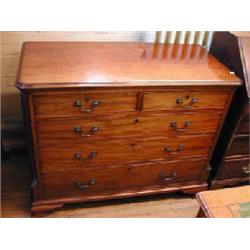 A George III mahogany chest of two short and three long graduated drawers flanked by reeded colu...