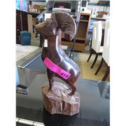 Wood carved statue of a mountain goat