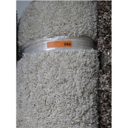 Beige shag carpet. Approx. 7' x 10'