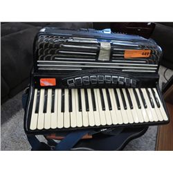Vintage accordion, with strap.