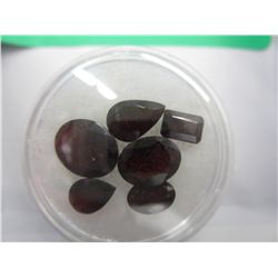 Six assorted cut red garnets