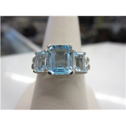 Emerald cut blue topaz & .06 carat diamond ring