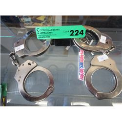2 Pairs of hand cuffs with connecting lock