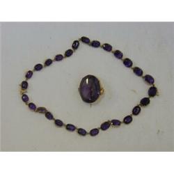 AN AMETHYST NECKLACE OF DEEP COLOUR, set in oval collets, with a matching larger brooch/pendant (