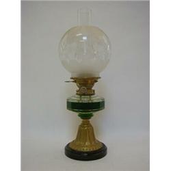 AN OIL LAMP, early 20th Century, part frosted globe shade, clear glass reservoir, brass trumpet b