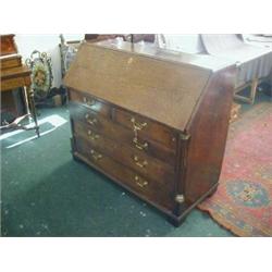 AN OAK BUREAU, c.1780, fall-front to an arrangement of pigeon holes and drawers, brass capped qua