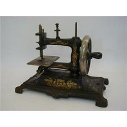 A GERMAN HAND OPERATED SEWING MACHINE, c.1920's, floral gilt decoration, metal cover  20-30