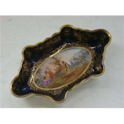 A PARIS PORCELAIN TRINKET DISH, c.1880, oval scene of figures and horse within a cobalt blue and