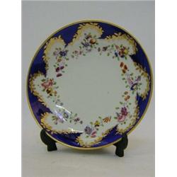 A BLOOR DERBY SAUCER DISH, c.1830, blue reserve, gilt border, polychrome floral swags, printed fa