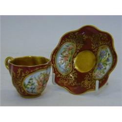 A MINIATURE COALPORT CABINET CUP AND SAUCER, c.1890, floral panels, gilt borders on a sang de boe