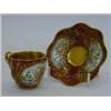 Image 1 : A MINIATURE COALPORT CABINET CUP AND SAUCER, c.1890, floral panels, gilt borders on a sang de boe