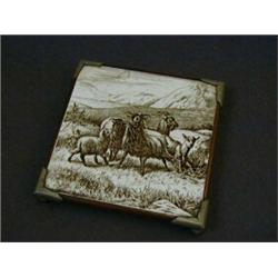 A MINTONS TILE TEA POT STAND, c.1890, underglaze sepia print of goats after Walter Crane, 14cm x